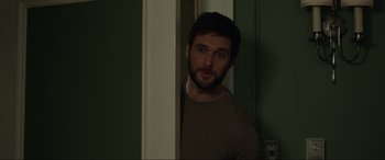 Movie still from “Brahms: The Boy II” (2020), directed by William Brent Bell – A man standing in front of a door looking at the camera; Close Up shot, Over the shoulder angle