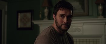 Movie still from “Brahms: The Boy II” (2020), directed by William Brent Bell – A person wearing a brown shirt; Close Up shot, Over the shoulder angle