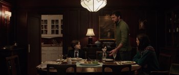 Movie still from “Brahms: The Boy II” (2020), directed by William Brent Bell – A man and two boys sitting at a dinner table; Medium shot, Over the shoulder angle