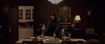 Movie still from “Brahms: The Boy II” (2020), directed by William Brent Bell – A woman and two boys sitting at a dinner table; Medium shot, Over the shoulder angle