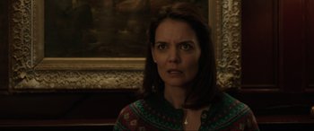 Movie still from “Brahms: The Boy II” (2020), directed by William Brent Bell – A person with a painting in the background; Close Up shot, Over the shoulder angle