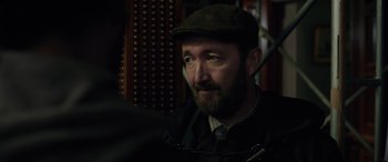 Movie still from “Brahms: The Boy II” (2020), directed by William Brent Bell – A man with a beard wearing a hat and jacket; Close Up shot, Over the shoulder angle