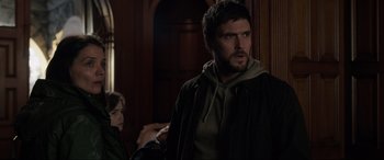 Movie still from “Brahms: The Boy II” (2020), directed by William Brent Bell – A man and a woman standing in front of a wall; Medium shot, Over the shoulder angle