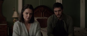 Movie still from “Brahms: The Boy II” (2020), directed by William Brent Bell – A woman and a man sitting next to each other in a room; Close Up shot, Over the shoulder angle