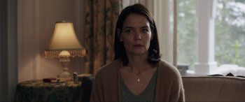 Movie still from “Brahms: The Boy II” (2020), directed by William Brent Bell – A woman in a brown sweater looking at the camera; Close Up shot, Over the shoulder angle