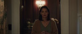 Movie still from “Brahms: The Boy II” (2020), directed by William Brent Bell – A woman is standing in front of a lamp; Medium shot, Over the shoulder angle