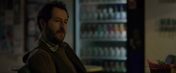 Movie still from “Brahms: The Boy II” (2020), directed by William Brent Bell – A person sitting in front of a refrigerator; Close Up shot, Over the shoulder angle