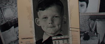 Movie still from “Brahms: The Boy II” (2020), directed by William Brent Bell – An old black and white photo of a young boy; Extreme Close Up shot, Overhead angle