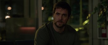 Movie still from “Brahms: The Boy II” (2020), directed by William Brent Bell – A person sitting in front of a window; Close Up shot, Over the shoulder angle