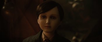 Movie still from “Brahms: The Boy II” (2020), directed by William Brent Bell – A doll's face in a dark room; Close Up shot, High angle