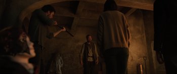 Movie still from “Brahms: The Boy II” (2020), directed by William Brent Bell – A group of people standing in a dark room; Medium shot, Over the shoulder angle