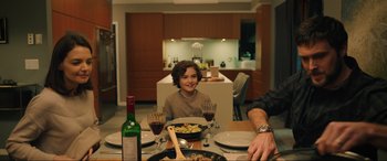 Movie still from “Brahms: The Boy II” (2020), directed by William Brent Bell – A young boy sitting at a dinner table with a plate of food; Medium shot, Over the shoulder angle