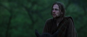 Movie still from “Braveheart” (1995), directed by Mel Gibson – A man with long hair and a beard is looking at the camera; Close Up shot, Low angle