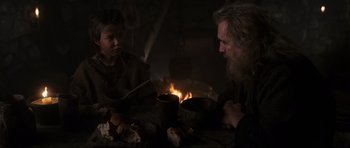 Movie still from “Braveheart” (1995), directed by Mel Gibson – A man and a woman sitting in front of a fire; Medium shot, Over the shoulder angle