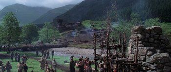 Movie still from “Braveheart” (1995), directed by Mel Gibson – A group of people standing next to each other near a river; Extreme Wide shot, High angle