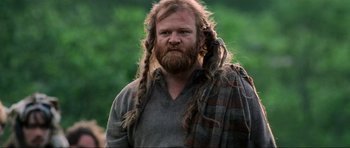 Movie still from “Braveheart” (1995), directed by Mel Gibson – A man with long hair and a long beard; Close Up shot, Low angle
