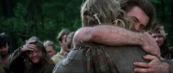 Movie still from “Braveheart” (1995), directed by Mel Gibson – A group of people standing next to each other in a forest; Close Up shot, Low angle