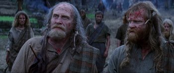Movie still from “Braveheart” (1995), directed by Mel Gibson – A group of men standing next to each other on top of a field; Close Up shot, Low angle