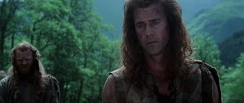 Movie still from “Braveheart” (1995), directed by Mel Gibson – A person with long curly hair; Close Up shot, Low angle