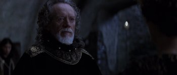 Movie still from “Braveheart” (1995), directed by Mel Gibson – An old man with a beard and a long white beard; Close Up shot, Over the shoulder angle
