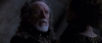 Movie still from “Braveheart” (1995), directed by Mel Gibson – An old man with a long white beard looking at a young woman; Close Up shot, Over the shoulder angle