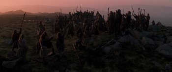 Movie still from “Braveheart” (1995), directed by Mel Gibson – A group of people standing on top of a grass covered hill; Extreme Wide shot, Low angle