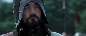 Movie still from “Braveheart” (1995), directed by Mel Gibson – A person with a beard wearing a helmet; Close Up shot, Low angle