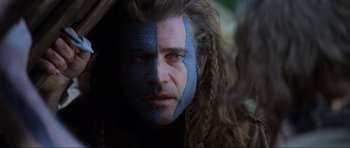 Movie still from “Braveheart” (1995), directed by Mel Gibson – A person with a face paint on; Close Up shot, Over the shoulder angle