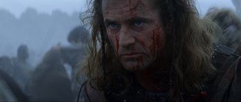 Movie still from “Braveheart” (1995), directed by Mel Gibson – A person with blood on his face; Close Up shot, Low angle
