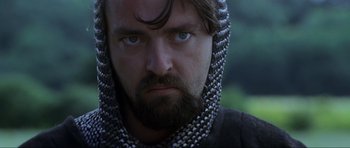 Movie still from “Braveheart” (1995), directed by Mel Gibson – A person wearing a chain mail hood; Close Up shot, Low angle