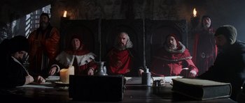 Movie still from “Braveheart” (1995), directed by Mel Gibson – A group of people sitting at a dinner table; Medium shot, Low angle