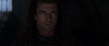 Movie still from “Braveheart” (1995), directed by Mel Gibson – A person with long dreadlocks; Close Up shot, Over the shoulder angle