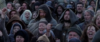 Movie still from “Braveheart” (1995), directed by Mel Gibson – A group of people wearing medieval garb in a crowd; Medium shot, High angle