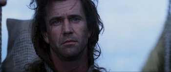 Movie still from “Braveheart” (1995), directed by Mel Gibson – A person with long hair; Close Up shot, Low angle
