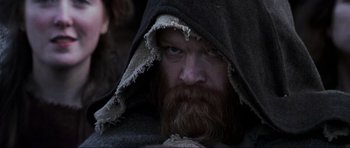 Movie still from “Braveheart” (1995), directed by Mel Gibson – A man with a long beard and a hooded jacket; Close Up shot, Low angle