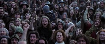 Movie still from “Braveheart” (1995), directed by Mel Gibson – A group of people are gathered together in the middle of a crowd; Medium shot, High angle