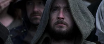 Movie still from “Braveheart” (1995), directed by Mel Gibson – A man with a beard is wrapped in a towel; Close Up shot, Low angle