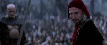 Movie still from “Braveheart” (1995), directed by Mel Gibson – An old man in a red hat is in front of a crowd of people; Close Up shot, Low angle