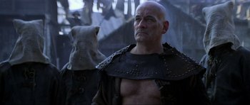 Movie still from “Braveheart” (1995), directed by Mel Gibson – A bald man in a leather jacket and a hood; Close Up shot, Low angle