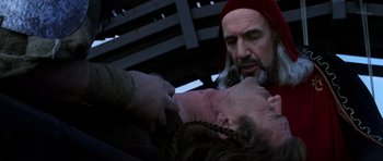 Movie still from “Braveheart” (1995), directed by Mel Gibson – A man with a beard and a red hat is holding a woman's head; Close Up shot, Over the shoulder angle