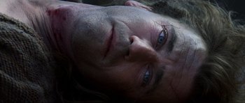 Movie still from “Braveheart” (1995), directed by Mel Gibson – A man's face with blue eyes; Extreme Close Up shot, Overhead angle
