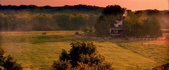 Movie still from “The Patriot” (2000), directed by Roland Emmerich – A house with a fence in the middle of a large field; Extreme Wide shot, High angle