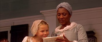 Movie still from “The Patriot” (2000), directed by Roland Emmerich – A woman and a girl are looking at a piece of paper; Close Up shot, Over the shoulder angle