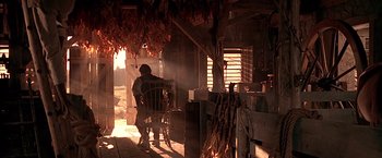 Movie still from “The Patriot” (2000), directed by Roland Emmerich – A person standing in a room with a chair; Wide shot, Low angle