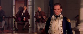 Movie still from “The Patriot” (2000), directed by Roland Emmerich – A man dressed in a uniform standing in front of two other men; Medium shot, Over the shoulder angle