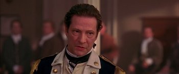 Movie still from “The Patriot” (2000), directed by Roland Emmerich – A person wearing a suit and tie; Close Up shot, Over the shoulder angle