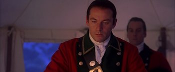 Movie still from “The Patriot” (2000), directed by Roland Emmerich – A person wearing a red and green jacket; Close Up shot, Low angle