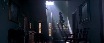 Movie still from “The Patriot” (2000), directed by Roland Emmerich – A man walking up a set of stairs with a baseball bat; Wide shot, Low angle