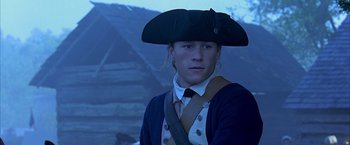 Movie still from “The Patriot” (2000), directed by Roland Emmerich – A young man in a pirate's outfit and a hat; Close Up shot, Over the shoulder angle