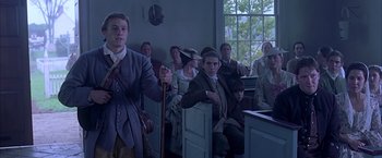 Movie still from “The Patriot” (2000), directed by Roland Emmerich – A group of people sitting in a room; Medium shot, Low angle